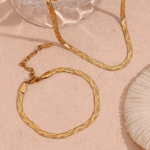 Detail of 18K gold plated herringbone chain necklace and bracelet with wavy texture