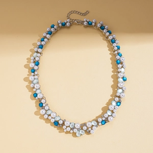 Detail showing faux pearls, turquoise beads and crystal accents on the silver-tone necklace