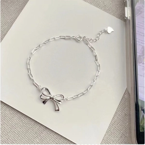 Elegant 925 sterling silver bow chain bracelet with an adjustable heart charm tag