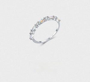Macro detail of S925 sterling silver ring with marquise opal and white zircon stones