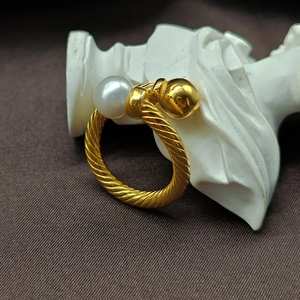 Retro twisted stainless steel gold open ring featuring a white pearl and polished bead
