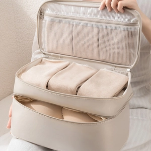Travel underwear organizer in beige with double-layer mesh compartments for bras and socks