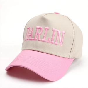 Detailed view of pink 3D embroidery showing DARLIN on a beige cotton baseball cap