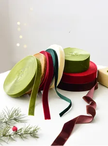 Close-up of multicolored velvet ribbon rolls for DIY Christmas gift wrapping and decor