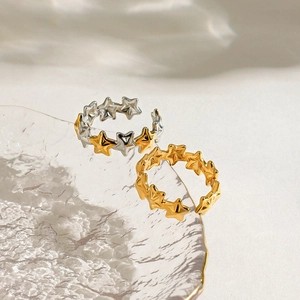 Polished 18K gold and silver star pattern adjustable open ring in a two-tone finish