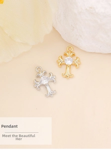 Macro view of gold and silver cross pendants with zircon inlay and relief carving