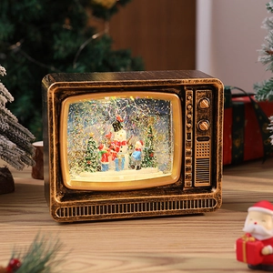 Close-up of vintage bronze TV snow globe with snowman and glittery swirling scene