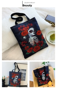 Detail of black canvas tote bag with artistic sugar skull and red rose woman print