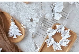 White glitter acrylic Christmas ornaments featuring snowflake, butterfly, and tree shapes