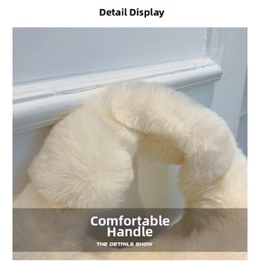 Detail of soft cream faux fur handle on a fluffy plush shoulder bag for women