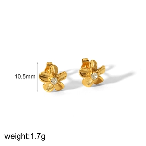 Macro shot of gold flower stud earrings featuring clear crystal centers and size labels