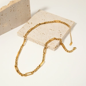 Gold titanium steel square bar and curb chain necklace on a minimalist stone background