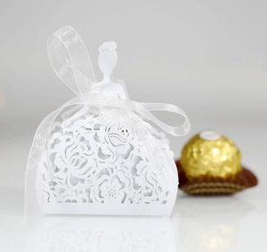 Detailed laser-cut white paper candy box with rose pattern and white ribbon for weddings