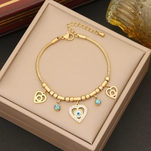 Golden snake chain bracelet with evil eye heart pendant and turquoise bead accents