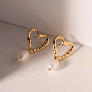 Golden heart earrings with hammered metal finish and elegant white pearl pendants