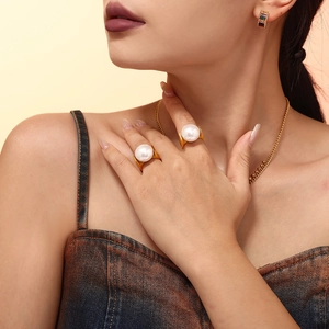 Exaggerated 18K gold plated titanium ring with large pearl worn by a female model