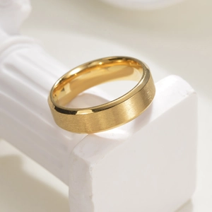 6mm minimalist gold frosted ring with brushed texture on white pedestal