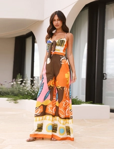 Detail of colorful digital print jumpsuit with front lace-up and wide-leg design