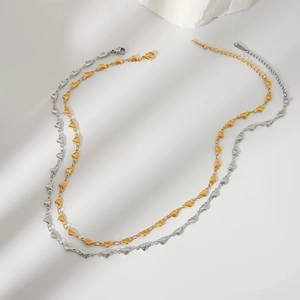 Minimalist 18K gold and silver heart link necklaces on a clean white background
