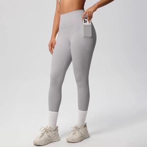 Close-up of high-waist yoga leggings with a functional side pocket holding a mobile phone
