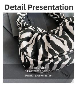 Macro detail of zebra print leather handbag with cloud-like gathered pleat texture