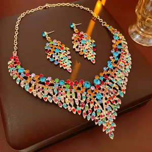 Vintage gold-tone jewelry set featuring colorful rhinestones and leaf motifs