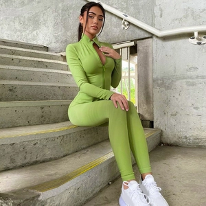Close-up of grass green ribbed yoga set with stand-up collar and high waist pants