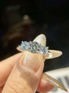 Macro close-up of a 925 sterling silver ring featuring three sparkling moissanite stones