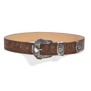 Detail of western brown leather belt with floral embossing and carved silver buckle