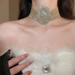 Macro shot of luxury gold oval choker necklace with shimmering rhinestones on a model