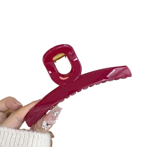 Elegant large deep red hair claw clip with glossy finish and strong gold metal spring