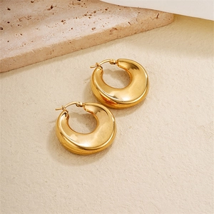 Chic polished gold geometric hoop earrings displayed on a minimalist stone background