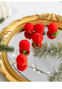 Macro view of red flocked mini apples on a vintage mirror for Christmas tree decoration