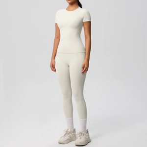 Slim fit women's yoga set featuring short sleeve top and high waist leggings in off-white