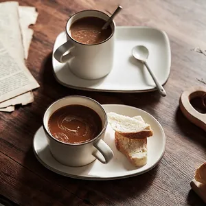 Japanese Banko-yaki ceramic coffee cup set with saucer on a dark wooden table background