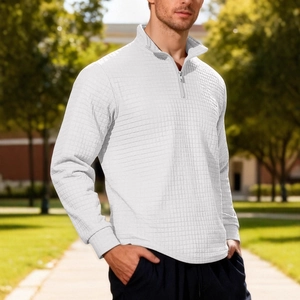 Men's white waffle knit half-zip sweatshirt featuring a grid texture in an outdoor setting