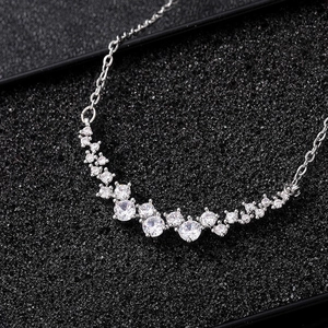 Sparkling silver smile pendant necklace with brilliant cubic zirconia on black texture