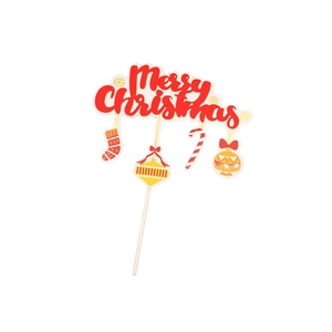 Macro shot of red Merry Christmas cake topper with festive stocking and candy cane