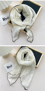 Detailed view of white cotton-linen scarf with scalloped edges and jacquard dots