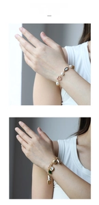 Detail of vintage gold bracelets featuring OT buckle, shell charms, and Evil Eye motifs