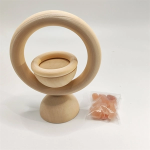 Close-up of natural wood essential oil diffuser stand with pink Himalayan salt stones