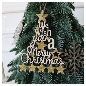 Detail of wooden Christmas tree ornament with golden glitter stars and holiday greeting