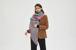 Close-up of pink and green leopard print scarf in soft boucle yarn with fringe