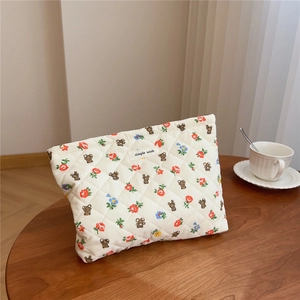 Detailed view of quilted cotton cosmetic bag with bear print and simple wish label
