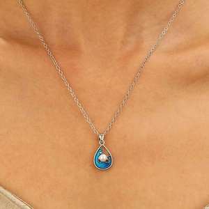 Detail of blue wave enamel teardrop pendant with pearl on a silver chain necklace