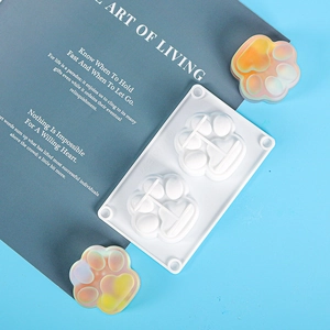 Detail of a 2-cavity cat paw silicone mold for DIY crafts with iridescent resin samples