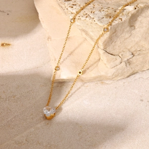 Detail of 18K gold-plated necklace featuring a large heart-shaped white zircon pendant