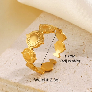 Detail of adjustable gold geometric ring with sunburst texture on stone base