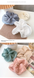 Detailed view of oversized organza scrunchies in five pearlescent shimmering colors