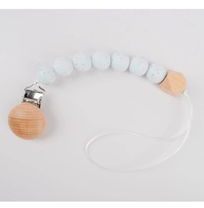 Close-up of silicone beads and beech wood clip on a white pacifier chain for babies